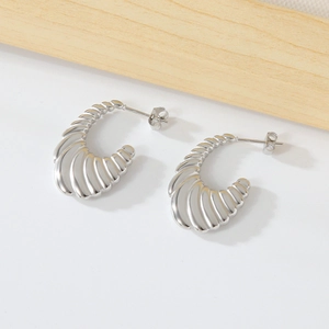 Minimalist silver croissant C-shaped earrings in polished stainless steel with texture