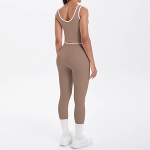 Detail of high-waist yoga leggings and crop top with contrast white piping