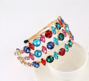 Detailed close-up of multi-layer golden headband with colorful rhinestones and gems