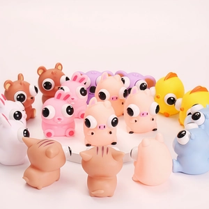 Close-up of various colorful cartoon animal squishy toys with popping eye features