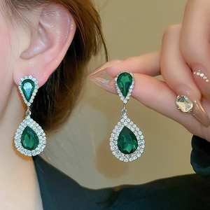 Detail view of vintage French style green water drop earrings with silver diamond inlay