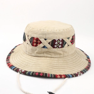 Detailed top view of khaki cotton sun hat with colorful tribal geometric embroidery and strap
