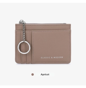 Macro view of apricot cross-grain leather card holder with zipper and keychain chain