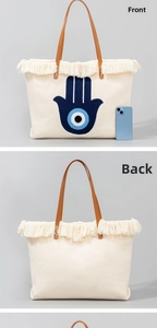 Detailed front and back view of a large canvas tote bag with bohemian evil eye embroidery