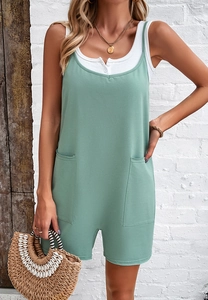 Close-up of green casual jumpsuit with dual pockets and loose fit design