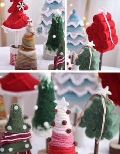 Detailed view of handmade wool felt Christmas trees in various colors with wood bases