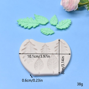 Leaf-shaped silicone mold for fondant and soap with green leaf samples on blue background