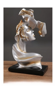 Macro shot of abstract resin lovers sculpture showing metallic texture and stable base