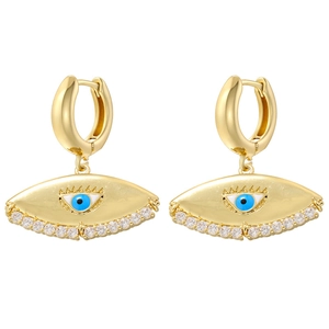 Detail of gold evil eye earrings with blue enamel and sparkling white zircon pavé
