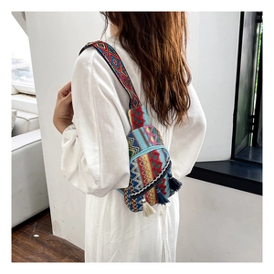 Close-up of bohemian woven chest bag with colorful tassels and adjustable wide strap