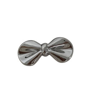 Silver metal bow-shaped hair clip with a sleek polished finish on white background