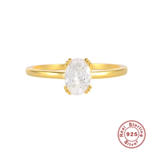 Macro detail of gold S925 sterling silver ring featuring a sparkling oval cut gemstone