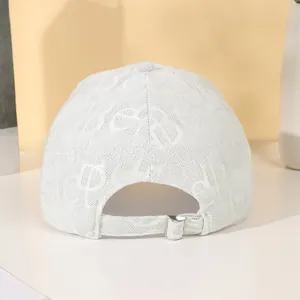 Detail view of white baseball cap back featuring silver adjustable buckle and textured fabric