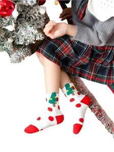 Christmas themed kids cotton socks featuring green tree embroidery and red polka dots