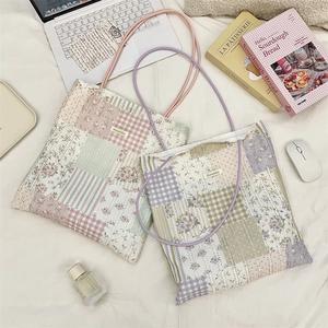 Detail of vintage patchwork tote bag with floral patterns and Sozakka woven label