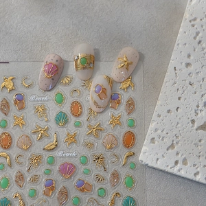 Golden embossed 3D ocean nail stickers with shells, seahorses and starfish designs