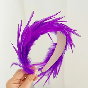 Detail of fluffy purple feather headband with vibrant textures and minimalist design