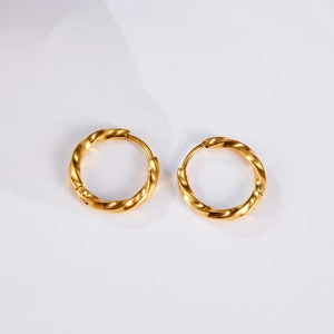 Detailed view of golden twisted Mobius hoop earrings with a textured spiral finish