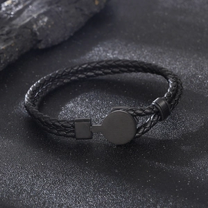 Macro shot of men's black braided leather bracelet with matte metal magnetic clasp