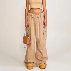 Khaki paratrooper cargo pants with drawstring waist and wide-leg baggy silhouette