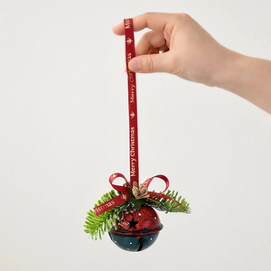 Hanging red and blue Christmas metal bells with pine needles and star cutouts
