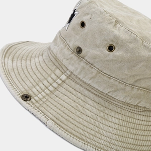 Vintage khaki canvas bucket hat with rhinestone star patch and copper metal eyelets