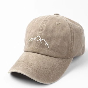 Macro detail of mountain peak embroidery on washed cotton khaki vintage baseball cap
