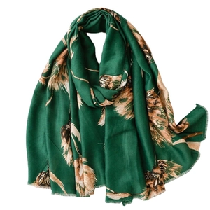 Emerald green scarf with gold feather patterns and fringe trim for winter