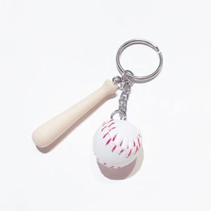 Detailed close-up of mini wooden baseball bat and white softball keychain with red stitching