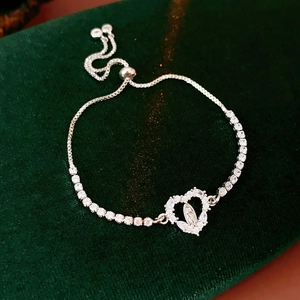 Detail of silver heart bolo bracelet with zircon stones and religious Virgin Mary icon