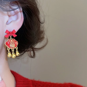 Detail of red bow earring with a lucky Fu cloud pendant and three golden bells