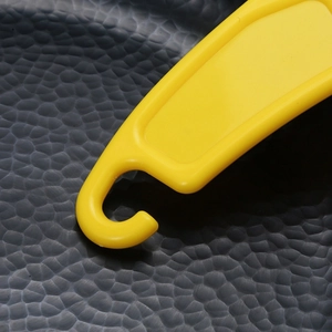 Yellow silicone kitchen scraper tool for cleaning oil stains on dishes and pans