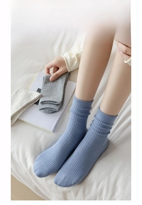 Detailed view of ribbed knit crew socks featuring flat toe seams and cotton texture