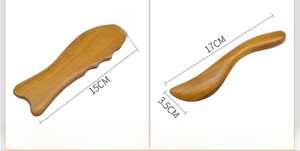 Close-up of Fish-shaped and S-shaped sandalwood massage tools with ergonomic design