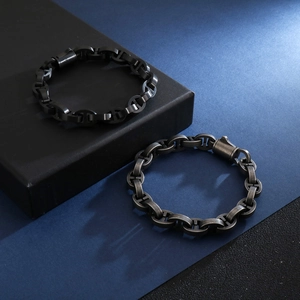 Detail of matte black and vintage silver steel chain bracelets with classic links