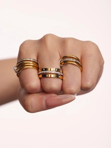 Macro detail of multi-layered mixed gold and silver rings with cubic zirconia pavé setting