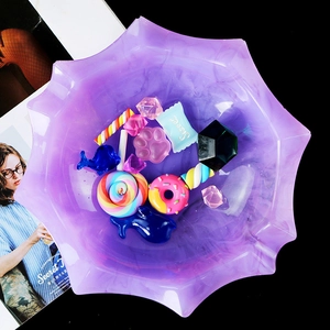 Detailed top view of a star-shaped purple resin tray filled with various colorful charms