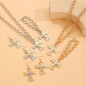 Macro detail of textured cross pendants in gold and silver finish with thick chains