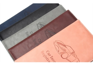 Detailed stack of multi-color leather car insurance and registration document holders