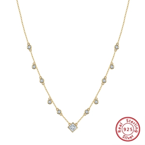 Detail of S925 sterling silver gold necklace with square pendant and sparkling zircon