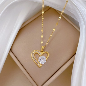 Titanium steel gold heart pendant necklace with full diamonds on white silk background