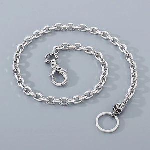 Detail of silver titanium skull keychain featuring a spring clasp and round key ring design