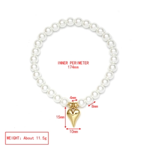 Detail of beaded pearl bracelet featuring gold heart charm with precise size measurements