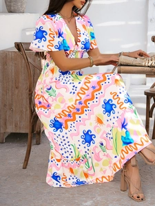 Detail of bohemian V-neck dress with abstract sun print and tiered cake-style skirt