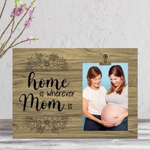 Close-up of wood photo frame with clip and home is wherever Mom is printed floral design