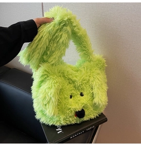 Detail of neon green plush dog face handbag with fluffy texture and black eyes