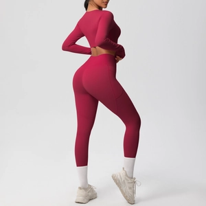 Close-up of high-waist fitness leggings side pocket on a burgundy yoga set