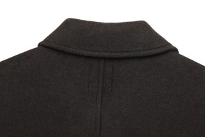 Detailed close-up of the back neckline and fine stitching on the black wool coat