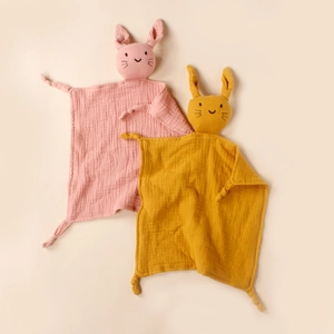 Detail of pink and ginger baby muslin cotton rabbit pacifier blankets and security toys