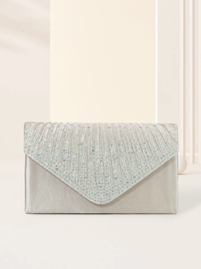 Detail of silver evening clutch with pleated fabric and radiant rhinestone flap
